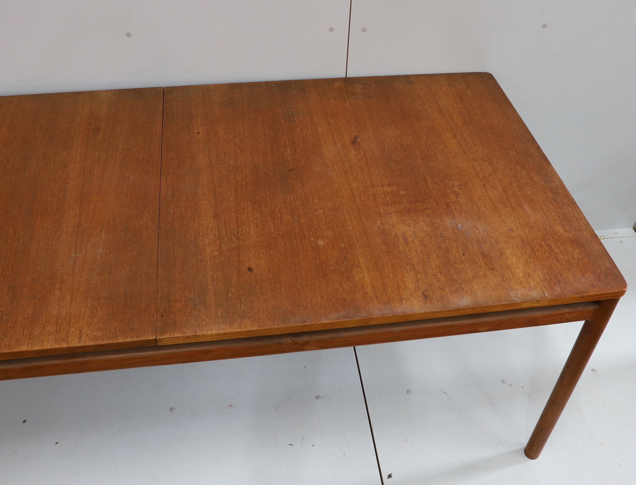A mid century Danish design rectangular teak extending dining table, width 200cm, depth 92cm, height 73cm